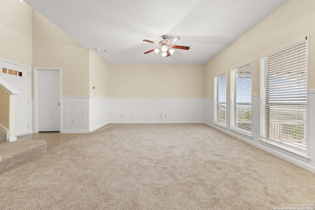 6739 Nora Vista Way, San Antonio, TX 78233 - unfurnished room featuring light carpet, ceiling fan, a decorative wall, and wainscoting