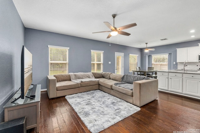 10607 Carmona, Helotes, TX 78023 - living area with ceiling fan and dark wood-style flooring