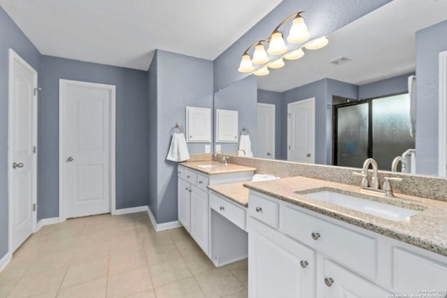 10607 Carmona, Helotes, TX 78023 - bathroom with baseboards, a stall shower, double vanity, and tile patterned flooring