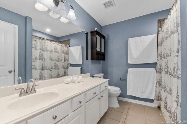 10607 Carmona, Helotes, TX 78023 - full bathroom featuring toilet, tile patterned floors, vanity, baseboards, and a shower with curtain