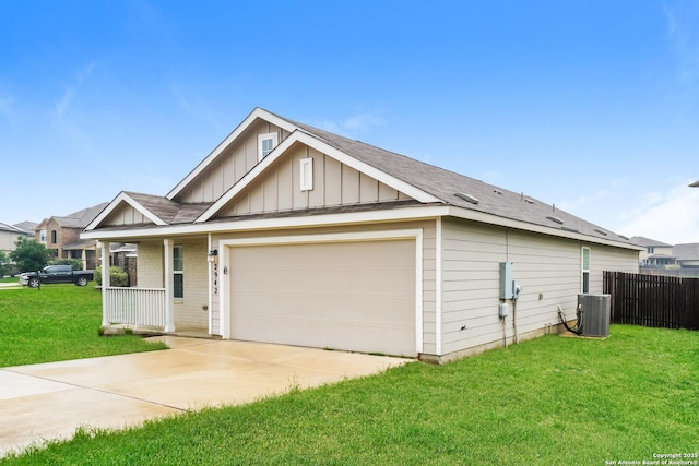 view of front of house featuring board and batten siding, a garage, concrete driveway, covered porch, and central AC unit