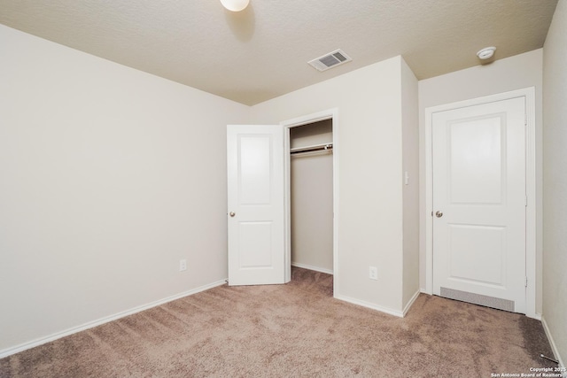 unfurnished bedroom with light carpet, baseboards, and a closet