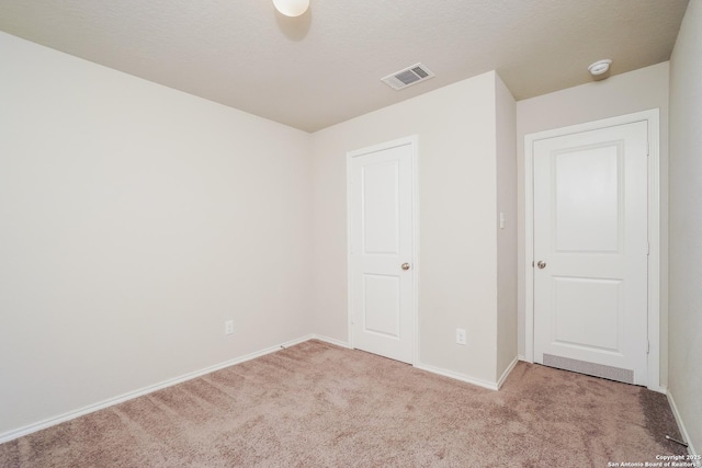 unfurnished bedroom with carpet flooring and baseboards