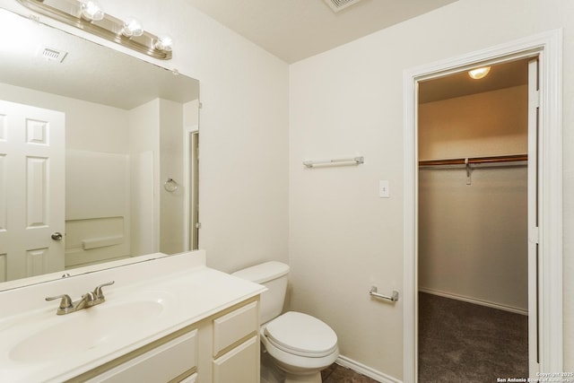 5503 Hidden, San Antonio, TX 78252 - full bathroom featuring toilet, vanity, and a walk in closet