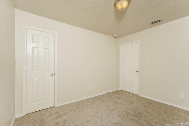 5503 Hidden, San Antonio, TX 78252 - carpeted empty room featuring baseboards and a textured ceiling