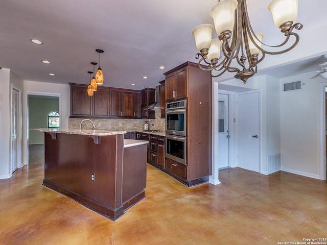 12802 Country Crst, San Antonio, TX 78216 - kitchen with appliances with stainless steel finishes, a chandelier, concrete floors, decorative backsplash, and recessed lighting