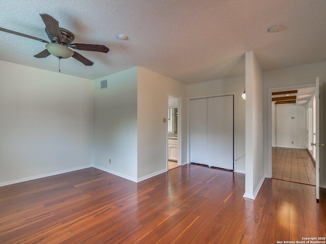 12802 Country Crst, San Antonio, TX 78216 - empty room featuring wood finished floors, a ceiling fan, a textured ceiling, baseboards, and a smoke detector