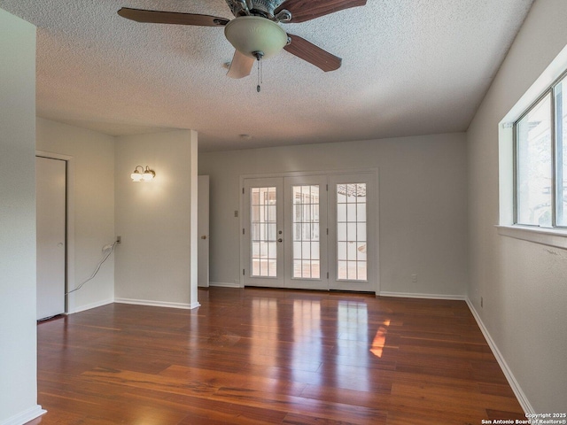 12802 Country Crst, San Antonio, TX 78216 - spare room featuring ceiling fan, a textured ceiling, wood finished floors, baseboards, and french doors