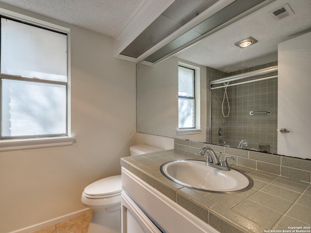12802 Country Crst, San Antonio, TX 78216 - bathroom featuring toilet, a tile shower, tile patterned flooring, vanity, and a textured ceiling