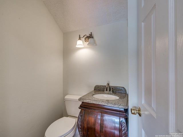 12802 Country Crst, San Antonio, TX 78216 - half bath featuring vanity, a textured ceiling, toilet, and lofted ceiling
