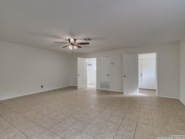12802 Country Crst, San Antonio, TX 78216 - spare room with ceiling fan, a textured ceiling, light tile patterned floors, and baseboards