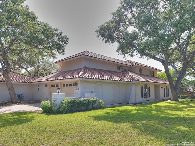 12802 Country Crst, San Antonio, TX 78216 - view of side of property with a tile roof, a lawn, a garage, concrete driveway, and brick siding