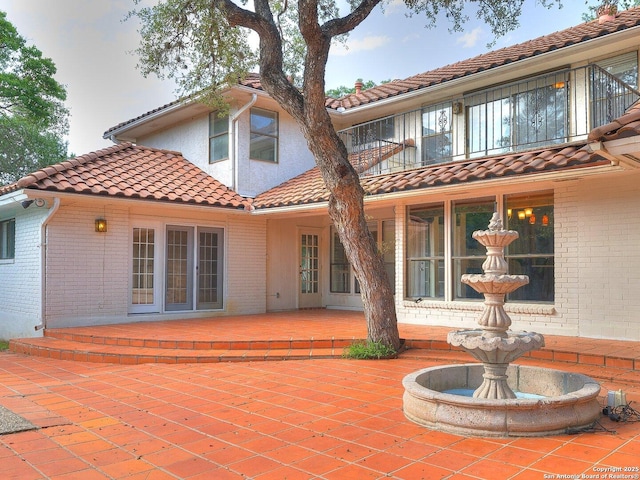 12802 Country Crst, San Antonio, TX 78216 - back of property with brick siding, a balcony, a patio, and a tile roof