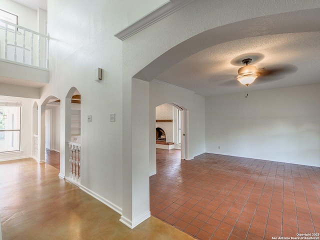 12802 Country Crst, San Antonio, TX 78216 - corridor featuring baseboards, a towering ceiling, and arched walkways