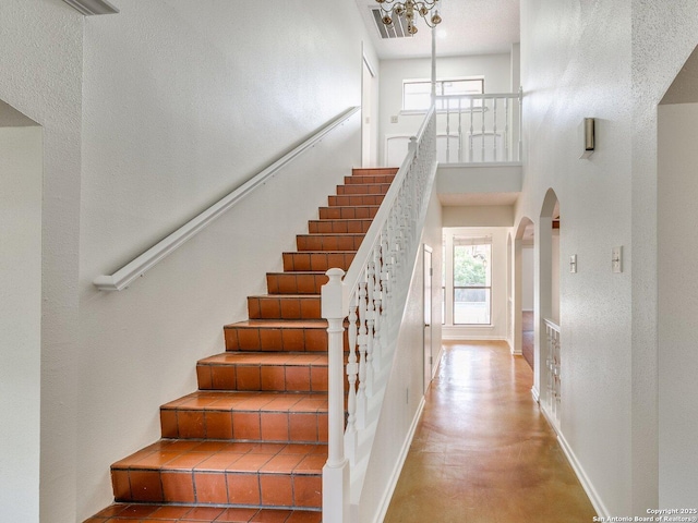 12802 Country Crst, San Antonio, TX 78216 - stairway with a towering ceiling, arched walkways, healthy amount of natural light, and baseboards