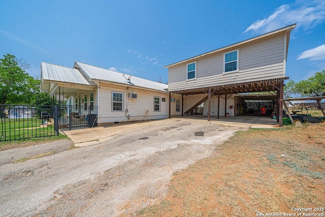 1004 Leona, Cotulla, TX 78014 - view of front of home with fence, metal roof, driveway, and a carport