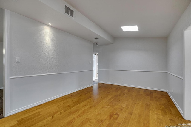 2802 Bent Bow, San Antonio, TX 78209 - empty room with light wood-style flooring, a skylight, and baseboards