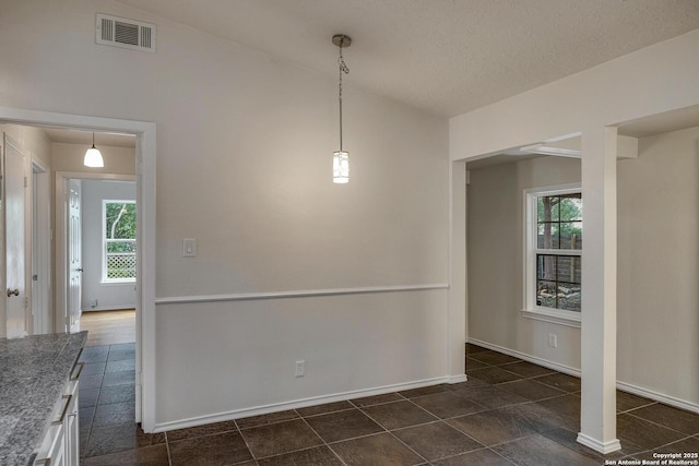 2802 Bent Bow, San Antonio, TX 78209 - unfurnished dining area with healthy amount of natural light, baseboards, and a textured ceiling