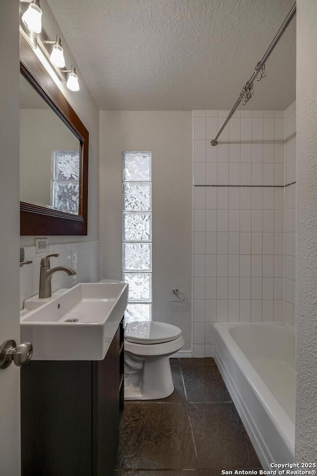 2802 Bent Bow, San Antonio, TX 78209 - bathroom featuring a textured ceiling, toilet, vanity, tile patterned flooring, and shower / bathtub combination
