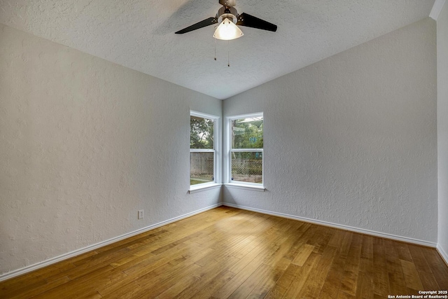 2802 Bent Bow, San Antonio, TX 78209 - unfurnished room with lofted ceiling, a textured wall, wood finished floors, a textured ceiling, and a ceiling fan
