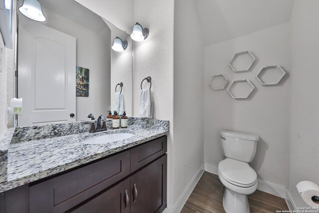 6514 Comanche Post, San Antonio, TX 78233 - half bathroom featuring toilet, wood finished floors, baseboards, and vanity