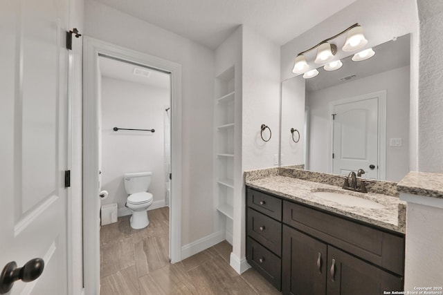 6514 Comanche Post, San Antonio, TX 78233 - full bathroom with vanity, toilet, and baseboards