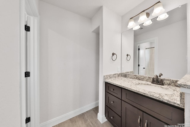 6514 Comanche Post, San Antonio, TX 78233 - bathroom with wood finished floors, baseboards, and vanity