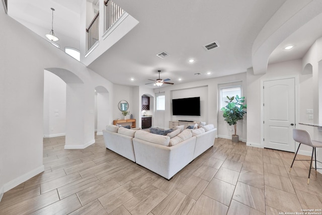 6514 Comanche Post, San Antonio, TX 78233 - living area featuring arched walkways, a ceiling fan, baseboards, and recessed lighting