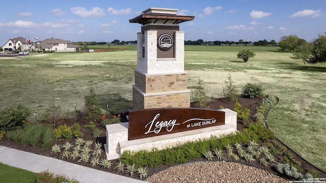 community sign with a rural view