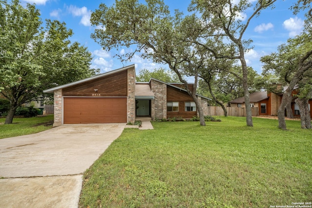 mid-century inspired home featuring concrete driveway and an attached garage