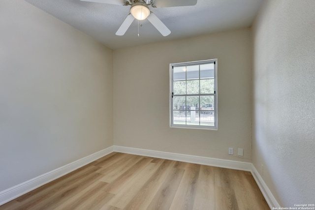 9015 Spanish Cv, San Antonio, TX 78242 - spare room with light wood finished floors, baseboards, and a ceiling fan