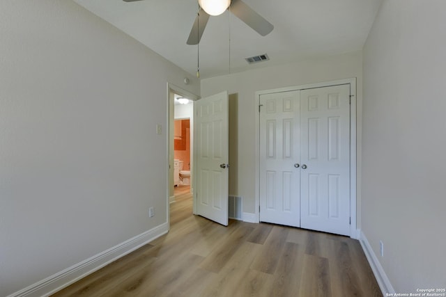 9015 Spanish Cv, San Antonio, TX 78242 - unfurnished bedroom with wood finished floors, baseboards, a closet, and ceiling fan
