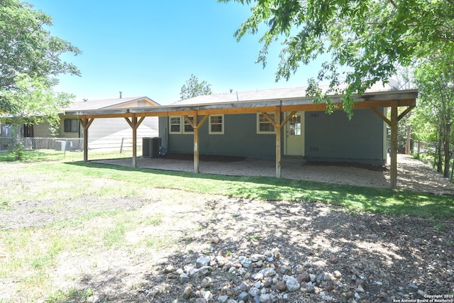 9015 Spanish Cv, San Antonio, TX 78242 - back of house with central AC unit, fence, an attached carport, and a patio area