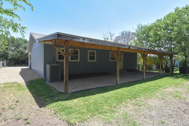 9015 Spanish Cv, San Antonio, TX 78242 - back of house with central air condition unit, an attached carport, a lawn, and a patio area