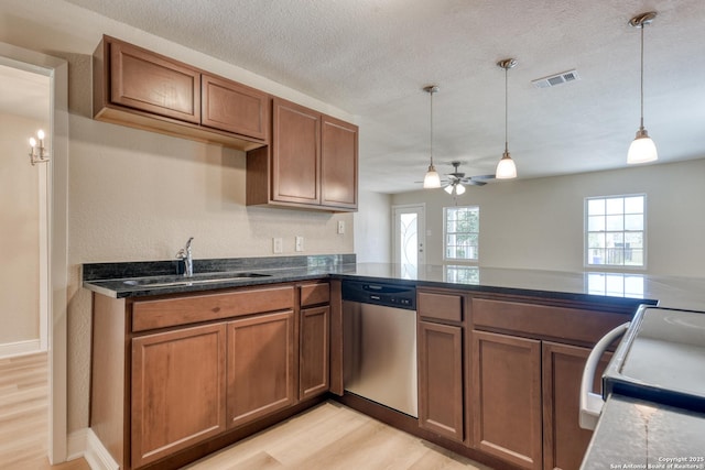 9015 Spanish Cv, San Antonio, TX 78242 - kitchen featuring dishwasher, a sink, range with electric stovetop, light wood finished floors, and brown cabinets