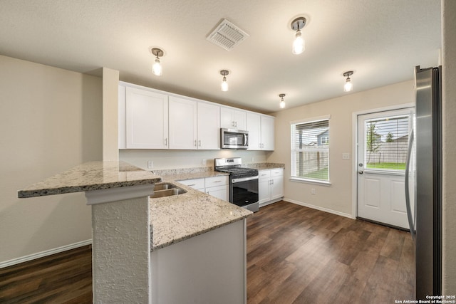 13758 Prospector Post, San Antonio, TX 78253 - kitchen featuring stainless steel appliances, a peninsula, baseboards, and dark wood finished floors