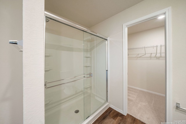 13758 Prospector Post, San Antonio, TX 78253 - full bathroom with a shower stall, a walk in closet, wood finished floors, and baseboards