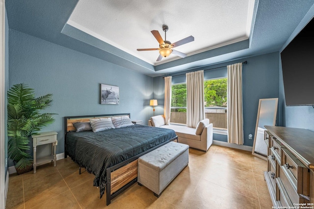 125 Stone Cyn, Fredericksburg, TX 78624 - bedroom featuring a raised ceiling, a textured ceiling, light tile patterned floors, a ceiling fan, and baseboards