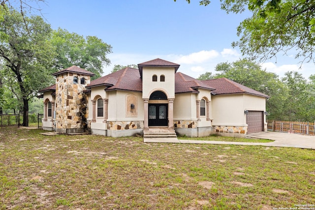 105 Saddle Up, La Vernia, TX 78121 - mediterranean / spanish house featuring stone siding, stucco siding, driveway, an attached garage, and french doors
