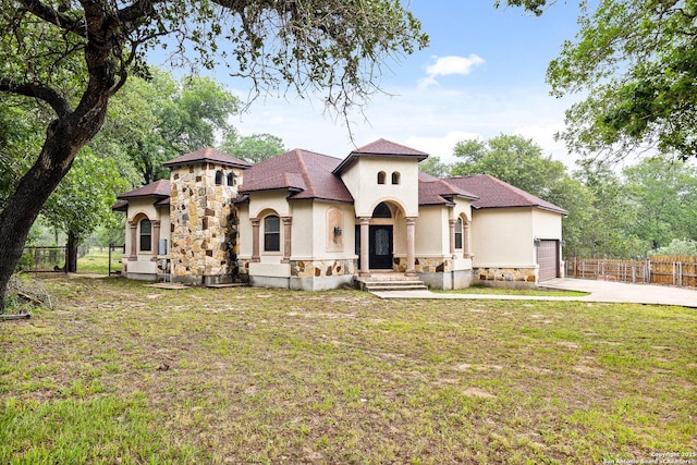 105 Saddle Up, La Vernia, TX 78121 - mediterranean / spanish house with stone siding, stucco siding, a garage, and concrete driveway