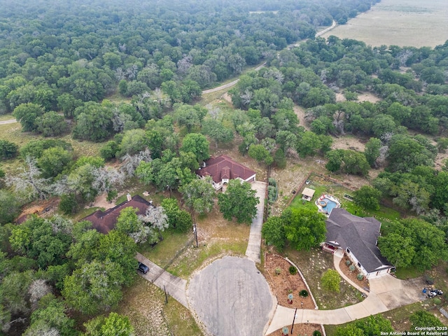 105 Saddle Up, La Vernia, TX 78121 - aerial overview of property's location featuring a forest