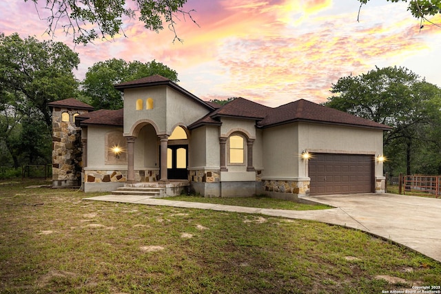 105 Saddle Up, La Vernia, TX 78121 - view of front of house featuring stone siding, stucco siding, concrete driveway, a garage, and roof with shingles