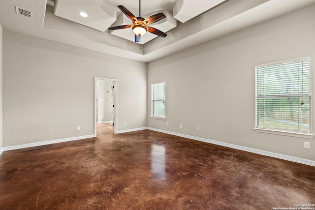 105 Saddle Up, La Vernia, TX 78121 - unfurnished room with concrete floors, a ceiling fan, a raised ceiling, baseboards, and recessed lighting