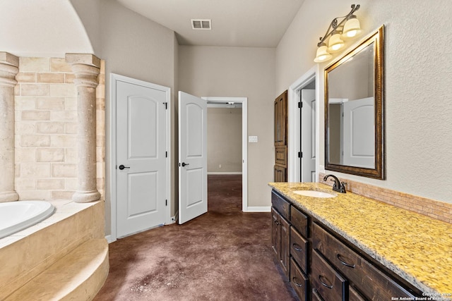 105 Saddle Up, La Vernia, TX 78121 - full bath with concrete floors, tiled bath, and vanity