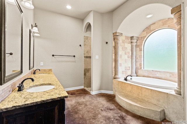 105 Saddle Up, La Vernia, TX 78121 - full bath with a bath, walk in shower, baseboards, and double vanity