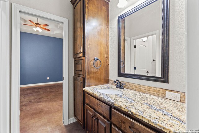 105 Saddle Up, La Vernia, TX 78121 - bathroom with vanity, baseboards, and a ceiling fan