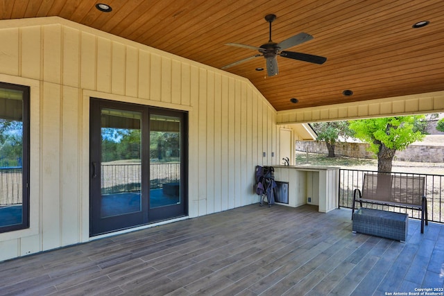 wooden deck featuring ceiling fan