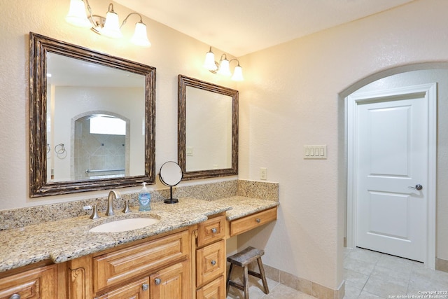 bathroom with tile patterned flooring, vanity, and baseboards
