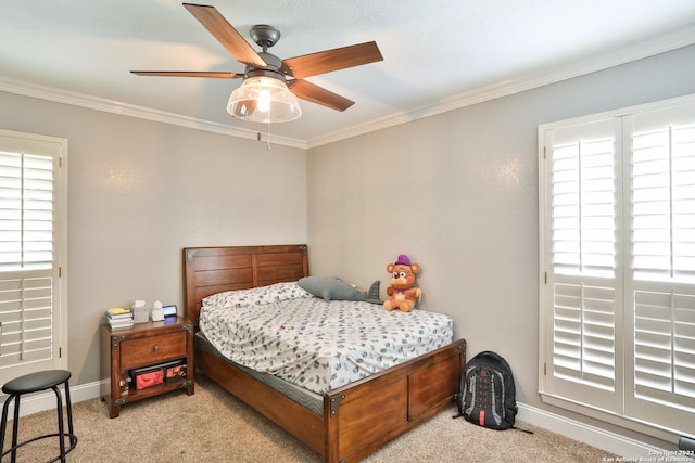 carpeted bedroom with ornamental molding, multiple windows, baseboards, and a ceiling fan