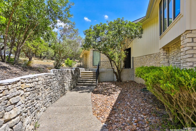 view of property exterior with stone siding